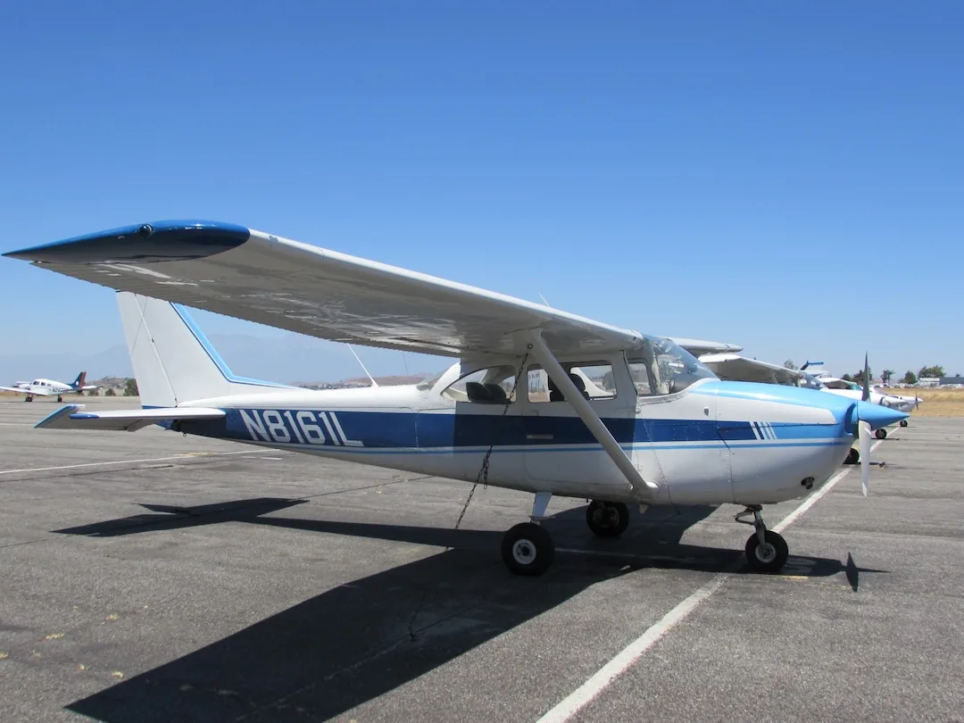 Side view of a Cessna high-wing single-engine training aircraft at Riverside Municipal Airport