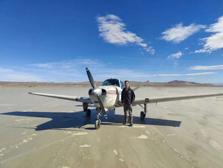 Training aircraft parked on a high-desert dry lake bed near Redlands