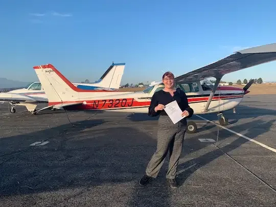 Student pilot celebrating after passing the checkride at Riverside Municipal Airport
